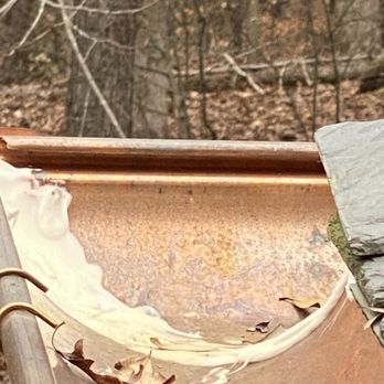 Guy Roofing - Highly visible white caulking used on copper gutters when it was supposed to be soldered. - Roofing Near Me - Spartanburg, South Carolina