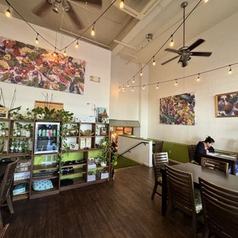 SixtyTwo MarcKet - a woman sitting at a table - New American Near Me - Wailuku, Hawaii