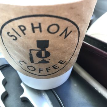 Siphon Coffee - Latte with branded cardboard protection sleeve since this one is hot unlike the iced coffee situation ($4.00) - Cafes Near Me - Houston, Texas
