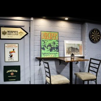 The Wild Goose - a table and chairs in front of a sign - Sports Bars Near Me - Woodside, New York The Wild Goose - a table and chairs in front of a sign - Sports Bars Near Me - Woodside, New York