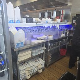 Orders left on the counter while the worker slowly puts them into bags Orders left on the counter while the worker slowly puts them into bags