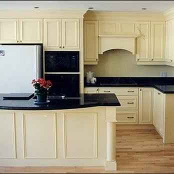 Steinbock Kitchens - a kitchen with white cabinets and black countertops - General Contractors Near Me - Pickering, Ontario Steinbock Kitchens - a kitchen with white cabinets and black countertops - General Contractors Near Me - Pickering, Ontario
