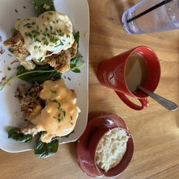 Eggs Cochon, eggs fried chicken, with. Side of grits and coffee