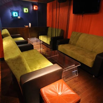 China Bar - couches and ottomans in a dimly lit room - Sports Bars Near Me - Flushing, New York