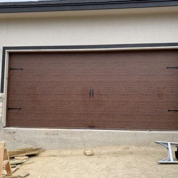 Perry's Garage Door Services - Modern flush: walnut oak finish with decorative hardware. - Garage Door Services Near Me Perry's Garage Door Services - Modern flush: walnut oak finish with decorative hardware. - Garage Door Services Near Me