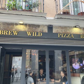 Brew Wild Pizza Bar - Street face. There's a huge 'cava' downstairs so don't let the intimate upstairs fool you. - Beer Bar Near Me - Madrid, M
