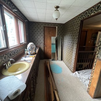 Woodwrx - a bathroom with a sink and a mirror - General Contractors Near Me
