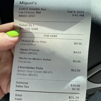 Miguel's - a person holding a receipt in their hand - Mexican Near Me - Las Cruces, New Mexico