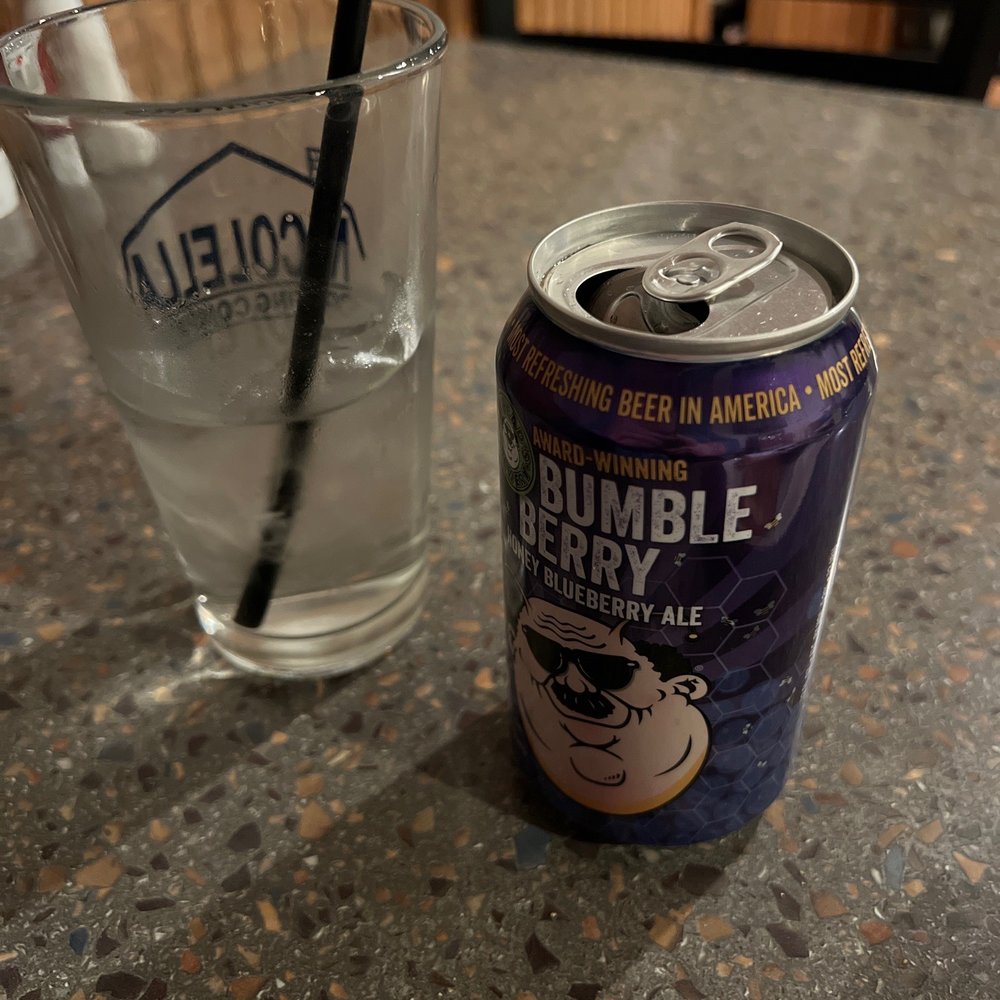 a can of kopper kettle and a glass of water a can of kopper kettle and a glass of water
