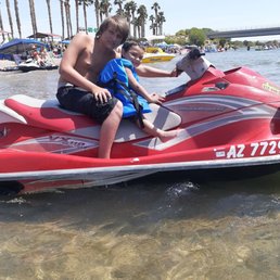 My little brother and son sitting on the jet ski.