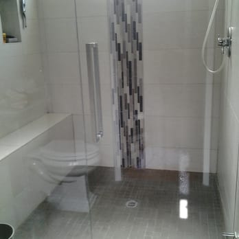 Bowers Tile - a shower with a glass door - General Contractors Near Me