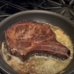 steak cooking in a frying pan