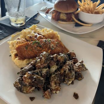 District Bar and Kitchen - Salmon with Grits and Brussel sprouts - Bars Near Me - Ocala, Florida District Bar and Kitchen - Salmon with Grits and Brussel sprouts - Bars Near Me - Ocala, Florida