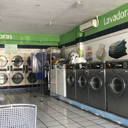 Lavanderia 2000 - Small washing machines to the right and dryers in the back.
