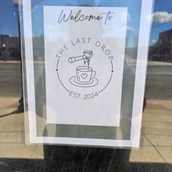 The Last Drop Coffee Shop - Welcome sign on entry door of Coffee Shop.