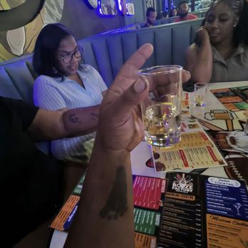 Booze Factory - The Size of the shots in here. My wife's arm, my sister and her bestie in the background. - Indian Near Me - Memphis, Tennessee Booze Factory - The Size of the shots in here. My wife's arm, my sister and her bestie in the background. - Indian Near Me - Memphis, Tennessee