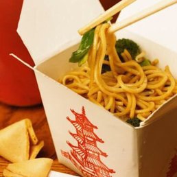 noodles in a take out box with chopsticks