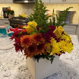 a vase of flowers on a kitchen counter