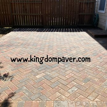 Kingdom Paver - a brick paver patio with a fence in the background - General Contractors Near Me Kingdom Paver - a brick paver patio with a fence in the background - General Contractors Near Me
