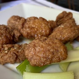 Boneless chicken wings with a garlic butter sauce with celery