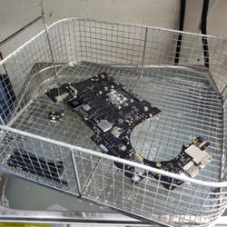 Ultrasonic washing A1502 Logicboard to remove corrosion then set for repair after drying.
