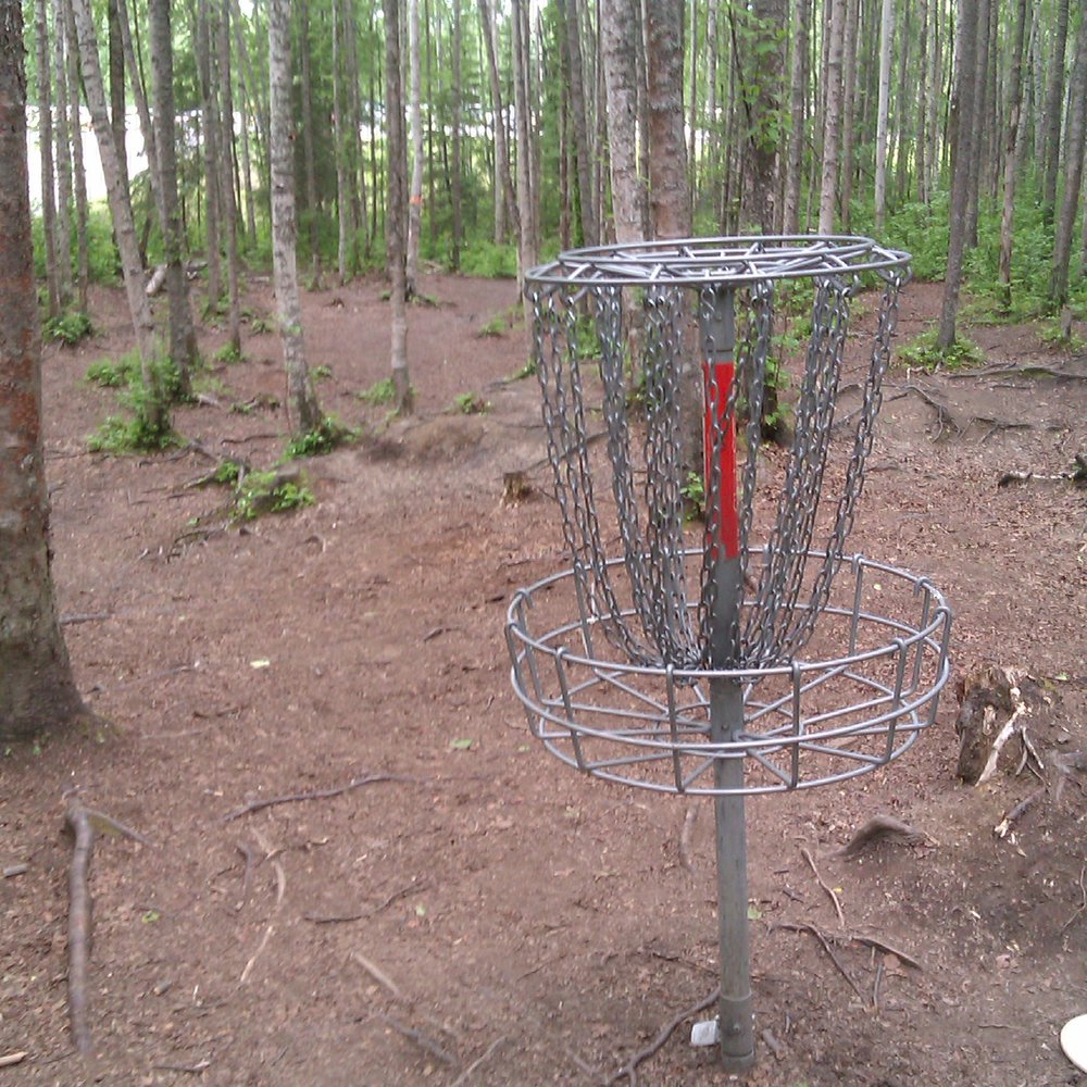 Peters Creek Disc Golf Course - Hole # 1 basket and fairway - Disc Golf Near Me - Chugiak, Alaska Peters Creek Disc Golf Course - Hole # 1 basket and fairway - Disc Golf Near Me - Chugiak, Alaska
