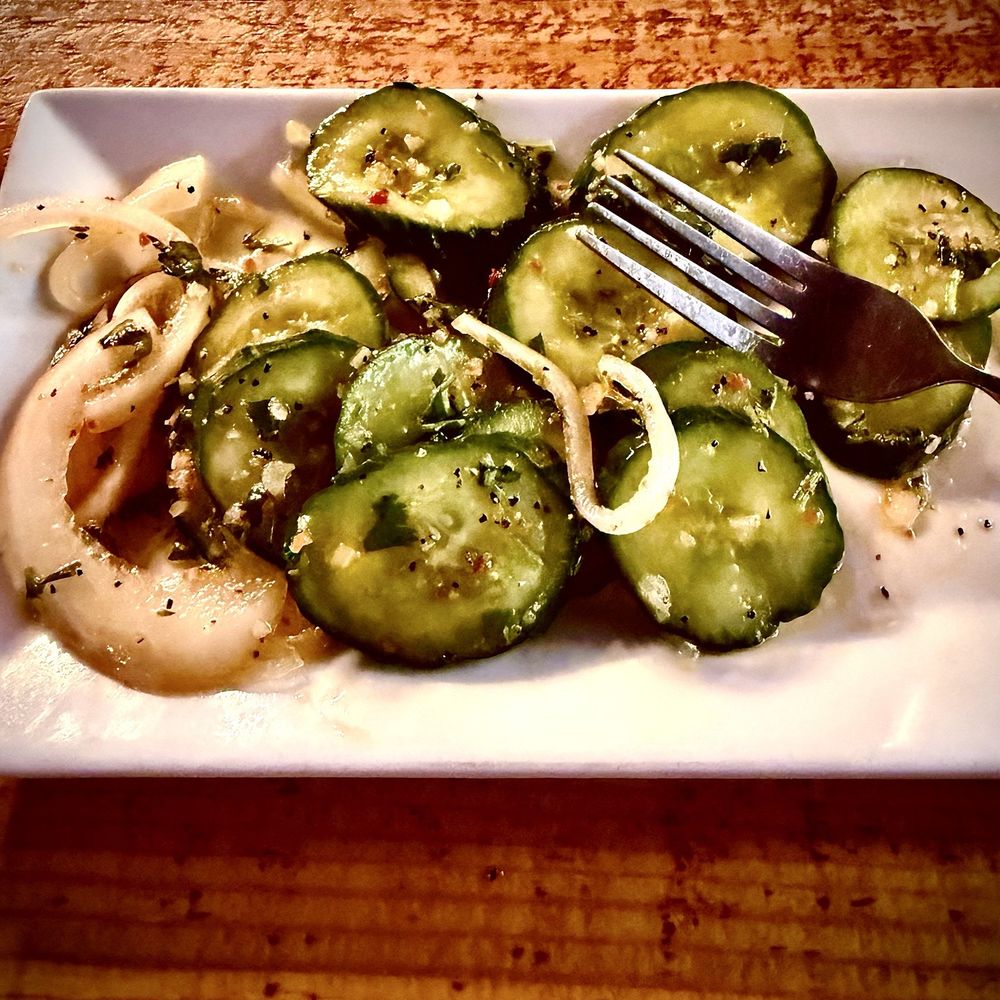 Elliotts an Urban Kitchen - Cucumber salad. Onions, oil, vinegar and peppery. Many spices. - New American Near Me - Spokane, Washington Elliotts an Urban Kitchen - Cucumber salad. Onions, oil, vinegar and peppery. Many spices. - New American Near Me - Spokane, Washington