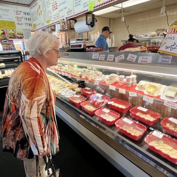 Big Apple Deli - a woman looking at meat - Delis Near Me - Oregon, Ohio Big Apple Deli - a woman looking at meat - Delis Near Me - Oregon, Ohio