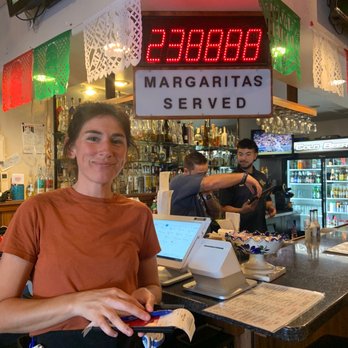 Reuben's Mexican Food - Our wonderful server by the Margaritas Served sign! That's a lot of Margaritas! - Mexican Near Me - Hilo, Hawaii Reuben's Mexican Food - Our wonderful server by the Margaritas Served sign! That's a lot of Margaritas! - Mexican Near Me - Hilo, Hawaii
