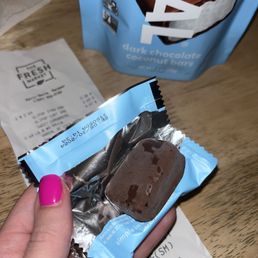 a hand holding a chocolate bar a hand holding a chocolate bar