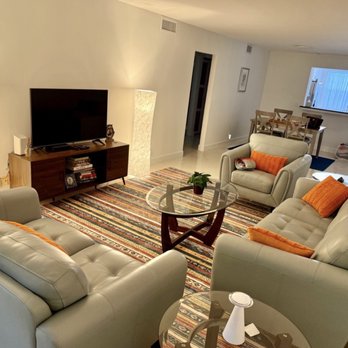 The Master Remodeling Group - Living room. Walk mirror and popcorn ceiling gone. Updated switches and fixtures. New baseboards. - General Contractors Near Me - Pompano Beach, Florida