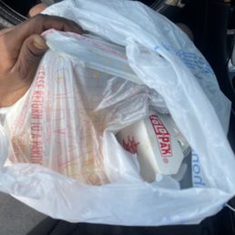 a man holding a bag of food a man holding a bag of food