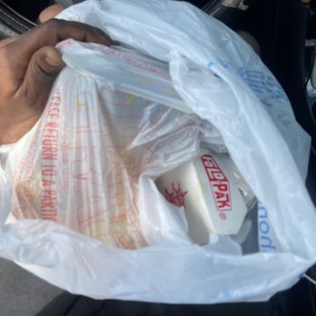 Village Wok - a man holding a bag of food - Chinese Near Me - Auburn, Alabama Village Wok - a man holding a bag of food - Chinese Near Me - Auburn, Alabama