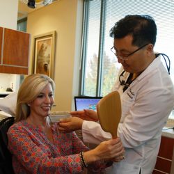 Henry Kim, DMD - Dr. Kim working with patient on her new smile.