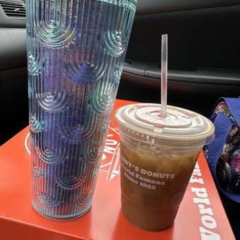 Randy’s Donuts - My $4 large iced coffee with oat milk next to my venti Starbucks cup for size comparison. - Coffee & Tea Near Me - San Diego, California