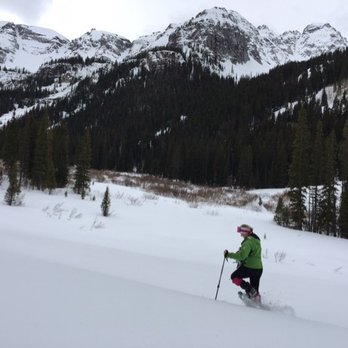 Wild Hare Snowshoe Tours - Lisa going off trail, in the powder. - Hiking Near Me - Telluride, Colorado