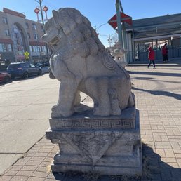A view of the ornate lion sculpture at the east corner of Chinatown Square Plaza