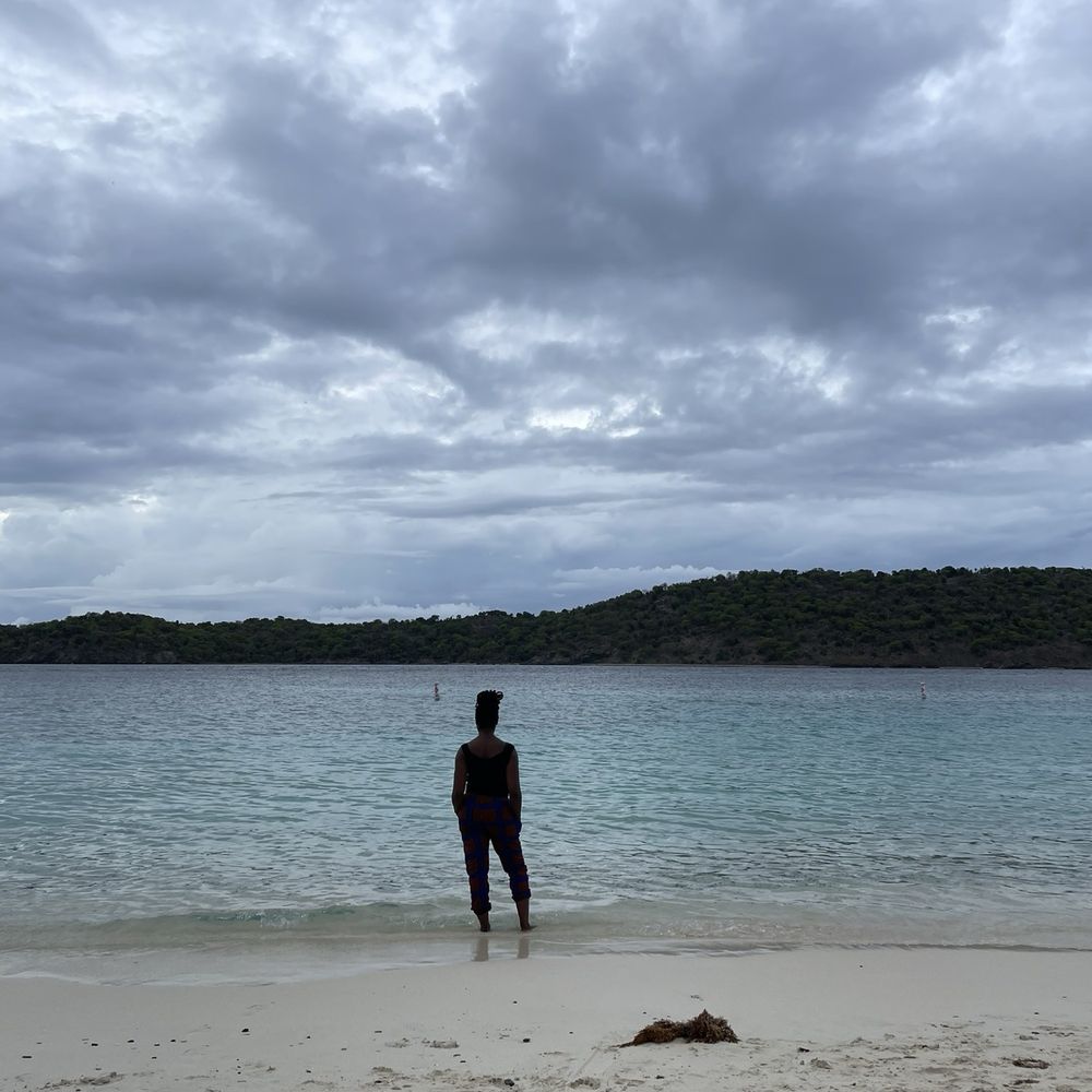 Coki Beach - Thatch Cay ahead and some special cutie standing at the water's edge. - Beaches Near Me - St Thomas, Virgin Islands