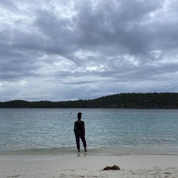 Coki Beach - Thatch Cay ahead and some special cutie standing at the water's edge. - Beaches Near Me - St Thomas, Virgin Islands