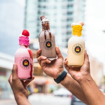 Shake Therapy - two people holding up bottles of milk - Desserts Near Me - Niagara Falls, Ontario