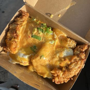 Rise Southern Biscuits & Righteous Chicken - BIG BREAKFAST BOX WITH TOTS, TWO FRIED EGGS, CHICKEN TENDERS, BOOM BOOM SAUCE, CHEDAR CHEESE AND GREEN ONION $12.57 - Chicken Shop Near Me - Winter Park, Florida