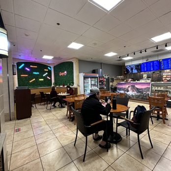Arepa Venezuelan Kitchen - Bellevue - a man sitting at a table - Empanadas Near Me - Bellevue, Washington