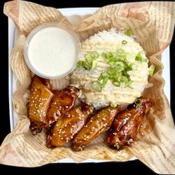 Manokan - Filipino BBQ bone-in wings with a side of rice topped with Sisig sauce
