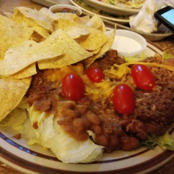 Frontier - "Taco salad"...looks like slop on a few pieces of lettuce with a few shreds of cheese and a lot of cheap tortilla chips. Cause, it is. - Mexican Near Me - Albuquerque, New Mexico