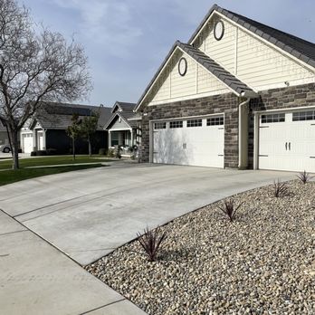 JJ Concrete & Landscaping - Flower bed with river rock - Landscaping Near Me