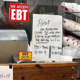 Sign at register regarding times.