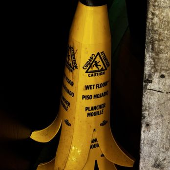 Puttshack - Denver - This banana shaped wet floor sign was the highlight of our visit - Mini Golf Near Me - Denver, Colorado