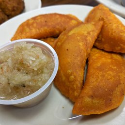 Panades: corn patties packed with sauteed buffalo fish and garnished with cabbage slaw.