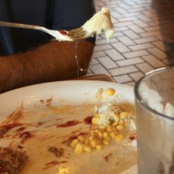 Cracker Barrel Old Country Store - Hair found in mash potatoes. It's partially hanging from the spoon.