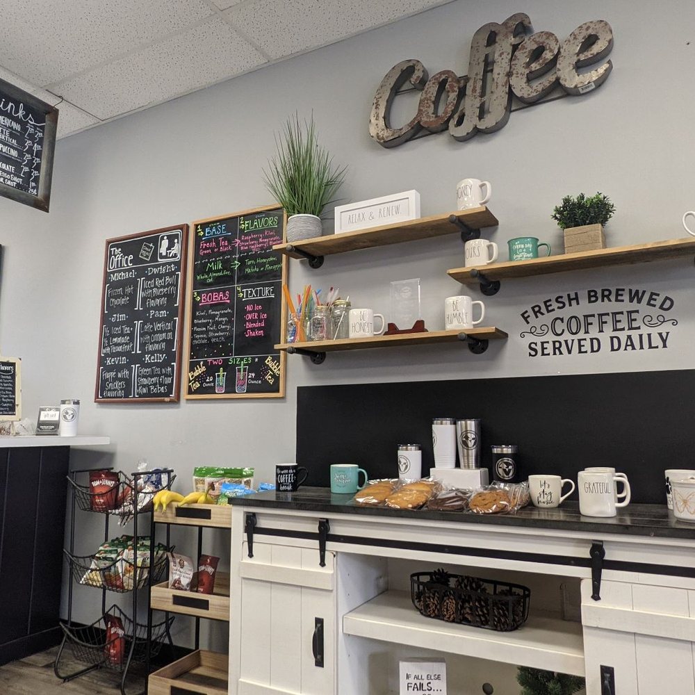 a coffee shop with a chalkboard menu on the wall a coffee shop with a chalkboard menu on the wall